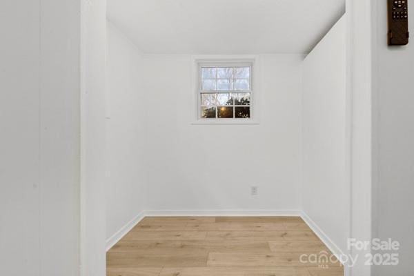 spare room with light wood-style floors and baseboards