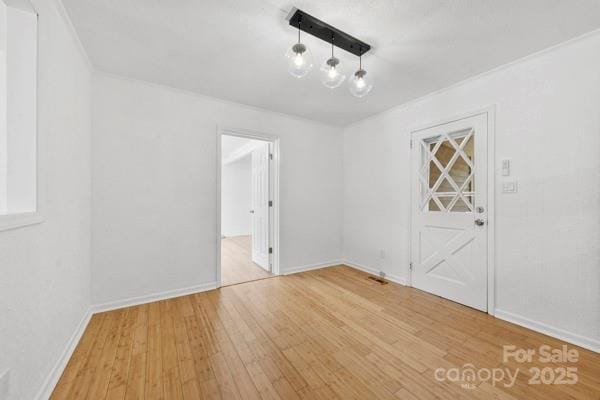 unfurnished dining area with light wood-type flooring and baseboards