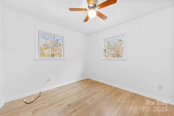 unfurnished room with light wood-style flooring, baseboards, and ceiling fan