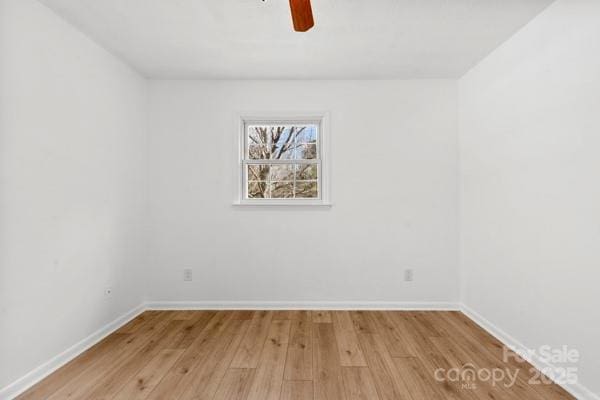 empty room with baseboards, ceiling fan, and light wood finished floors