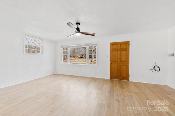 empty room with light wood-style flooring and ceiling fan