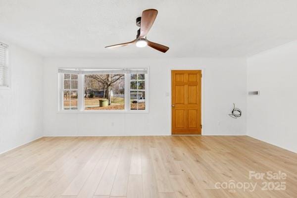 empty room with ceiling fan and wood finished floors