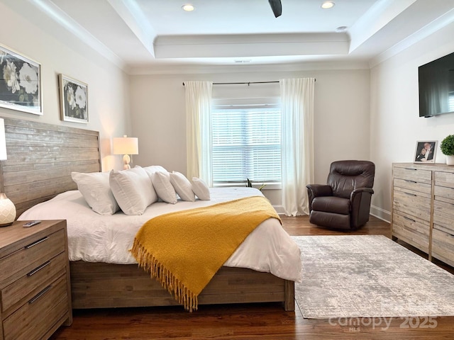 bedroom featuring crown molding, dark wood-type flooring, a raised ceiling, and recessed lighting