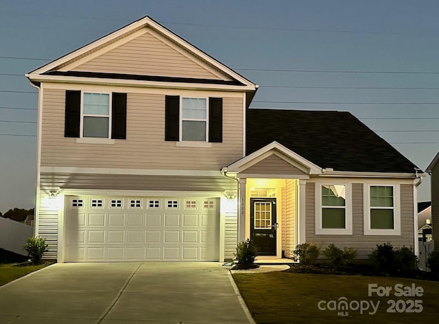 traditional-style house with concrete driveway and an attached garage