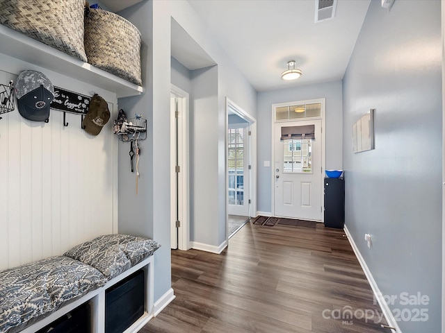 mudroom with dark wood-style flooring, visible vents, and baseboards