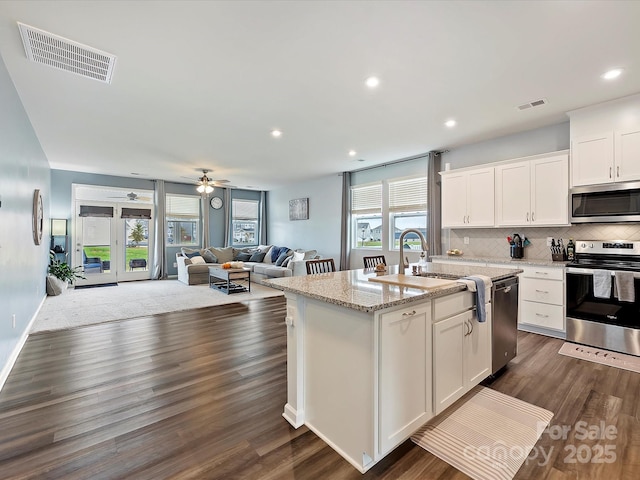 kitchen with visible vents, appliances with stainless steel finishes, decorative backsplash, and a sink