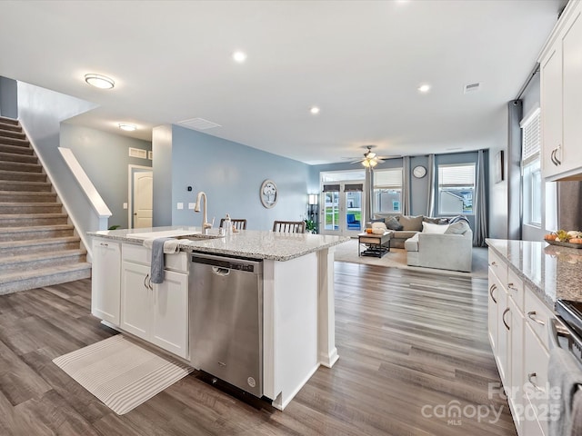 kitchen featuring dark wood-type flooring, white cabinetry, dishwasher, and an island with sink