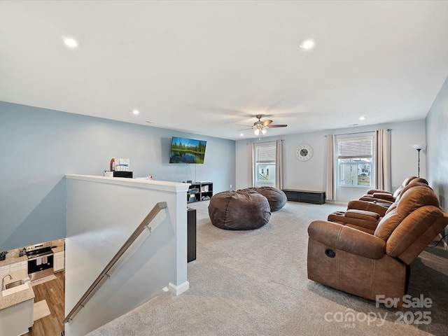 living area with light carpet, a ceiling fan, and recessed lighting