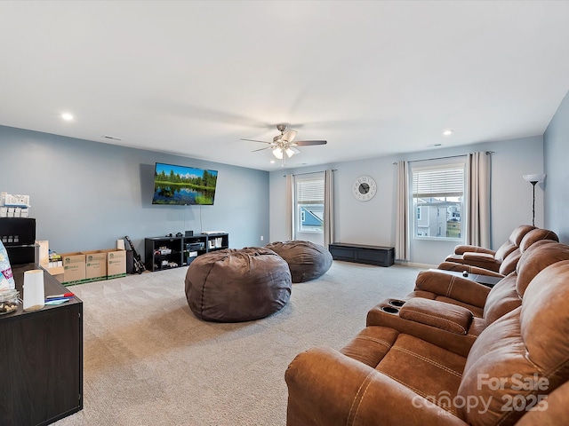 living area featuring light carpet, ceiling fan, and recessed lighting