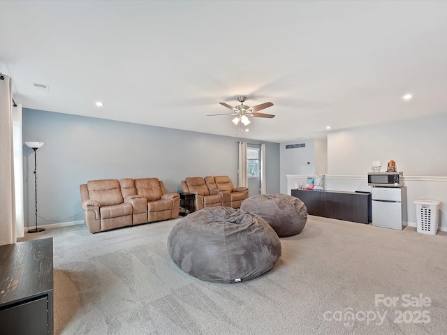 carpeted living area with visible vents, a ceiling fan, and recessed lighting