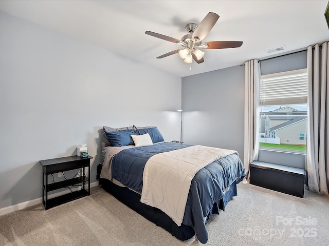 bedroom with a ceiling fan, baseboards, visible vents, and carpet flooring