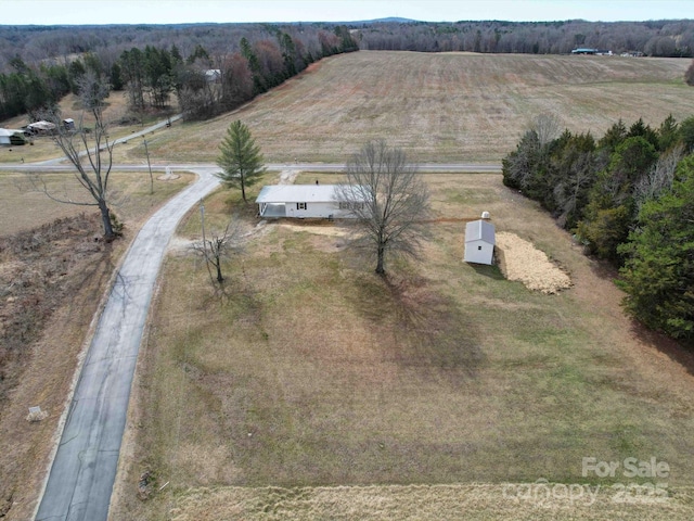 birds eye view of property with a rural view