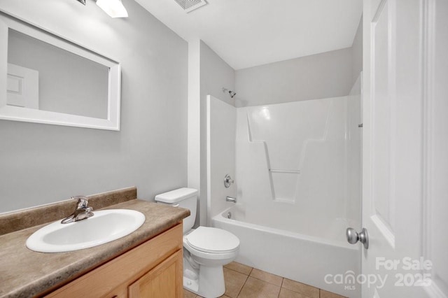 bathroom with washtub / shower combination, tile patterned flooring, vanity, and toilet