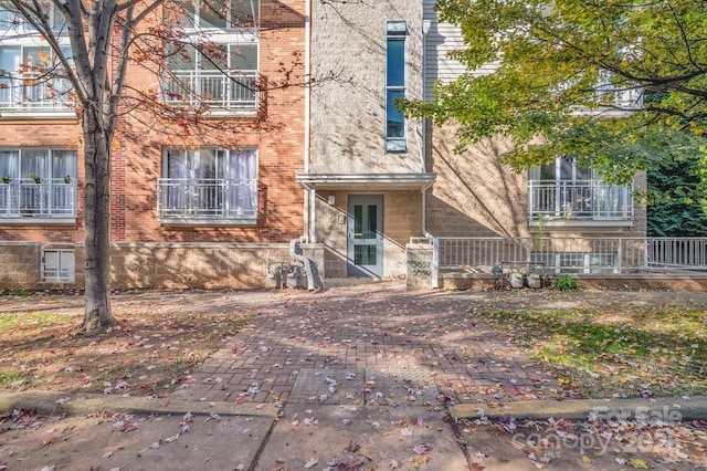 back of property featuring brick siding