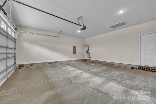 garage featuring a garage door opener and electric panel