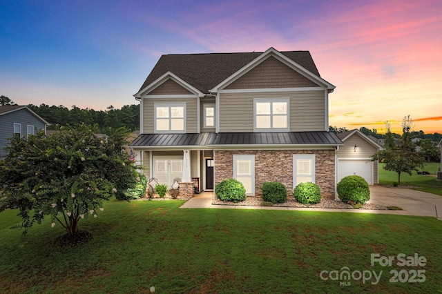 craftsman inspired home with a yard, a porch, a standing seam roof, stone siding, and driveway