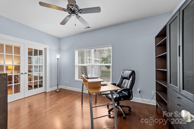 office space featuring ceiling fan, wood finished floors, visible vents, baseboards, and french doors