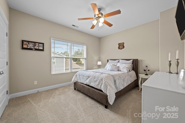 carpeted bedroom featuring baseboards, visible vents, and a ceiling fan