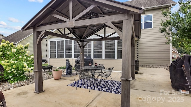 view of patio featuring a gazebo, outdoor dining space, and grilling area