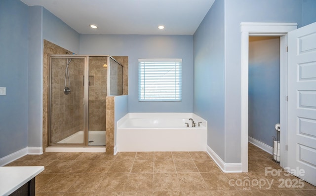 bathroom with tile patterned flooring, a shower stall, baseboards, and a bath