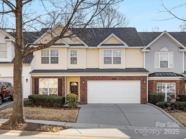 multi unit property featuring a garage, brick siding, driveway, and a shingled roof