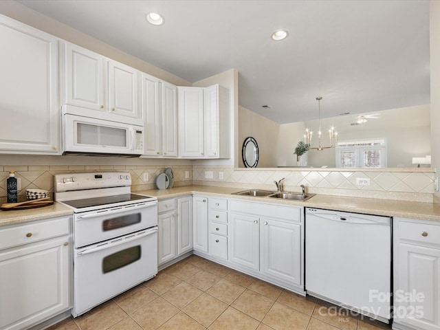 kitchen with white appliances, light tile patterned floors, a sink, decorative backsplash, and light countertops