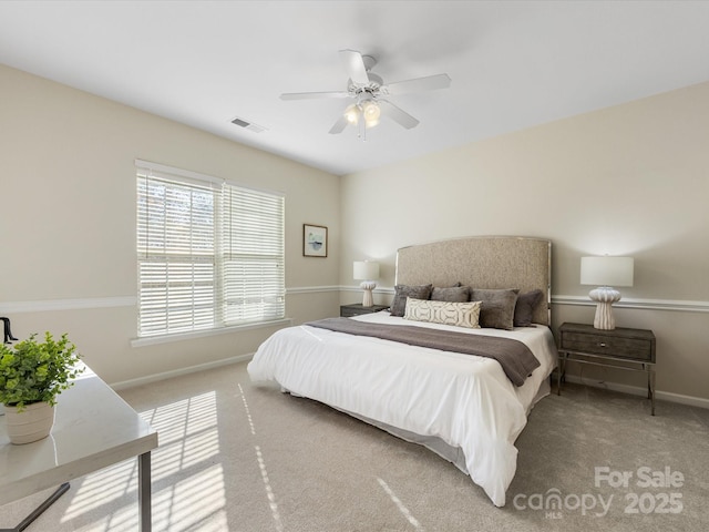 carpeted bedroom featuring visible vents, ceiling fan, and baseboards