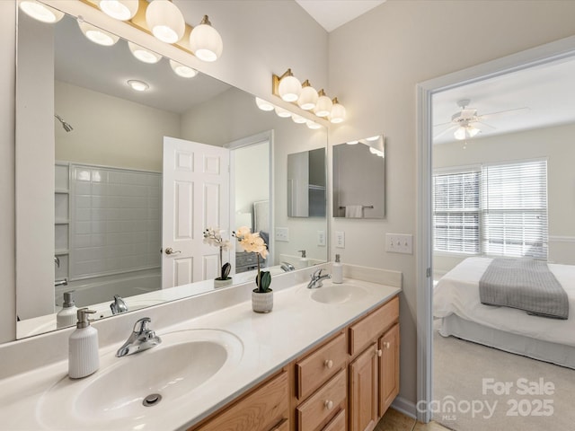 ensuite bathroom with a sink, double vanity, ceiling fan, and ensuite bathroom