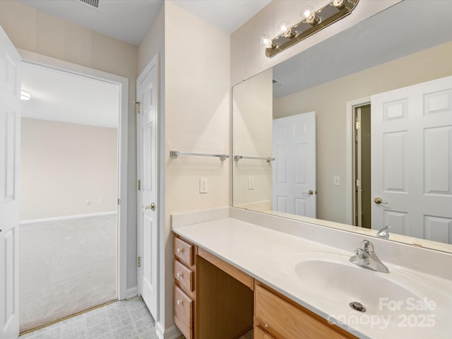 bathroom featuring vanity and baseboards