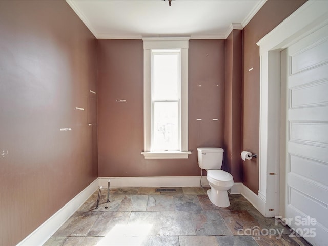 bathroom with ornamental molding, baseboards, visible vents, and toilet