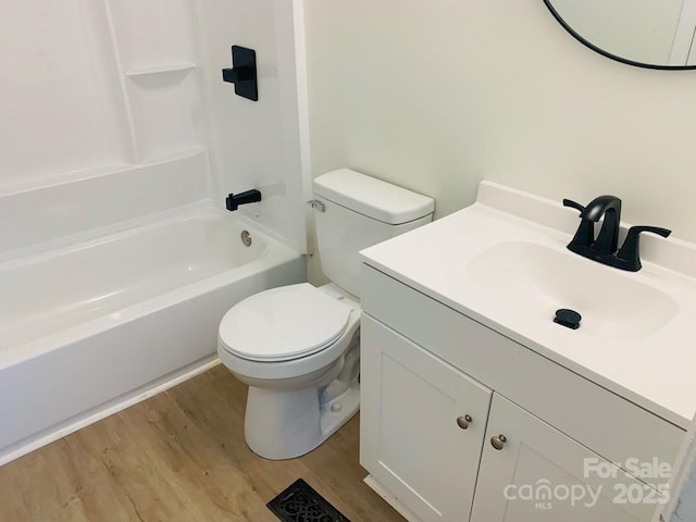 full bathroom with toilet, shower / bathtub combination, wood finished floors, and vanity