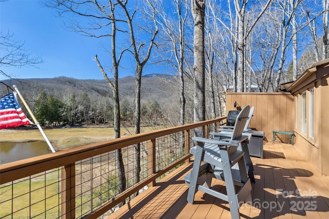 wooden deck with a mountain view and a wooded view