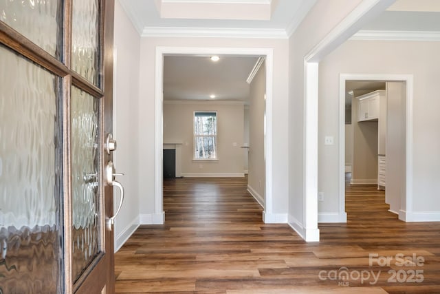 entrance foyer with baseboards, wood finished floors, and crown molding