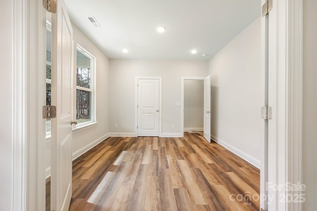 unfurnished bedroom featuring recessed lighting, baseboards, visible vents, and light wood finished floors