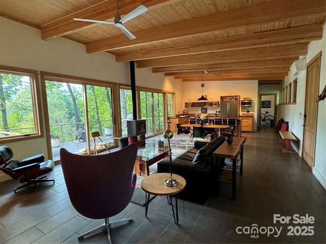 448 Mt Mitchell Dr, Burnsville, NC 28714 - living area with wood ceiling, a wood stove, ceiling fan, beamed ceiling, and an AC wall unit