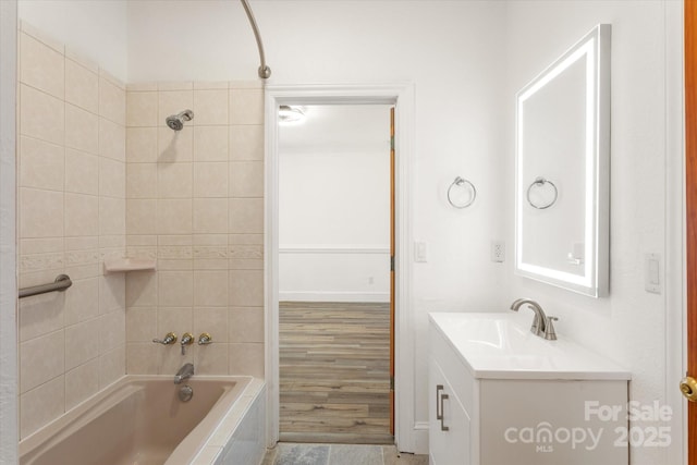 full bathroom featuring tiled shower / bath and vanity