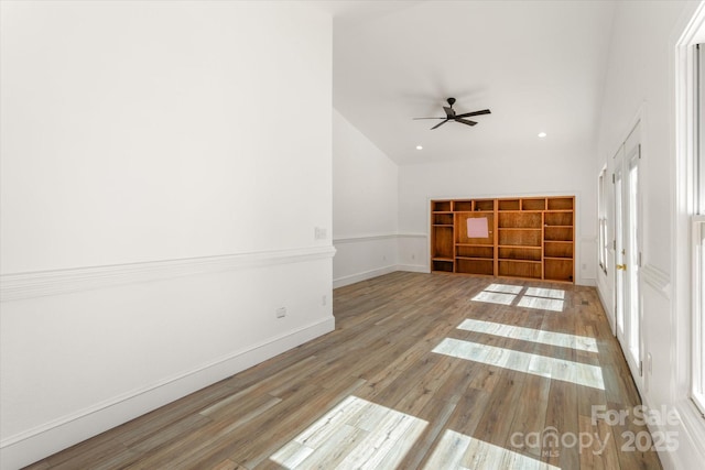 interior space with recessed lighting, ceiling fan, baseboards, and wood finished floors