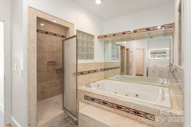 bathroom with a whirlpool tub, a stall shower, and vanity