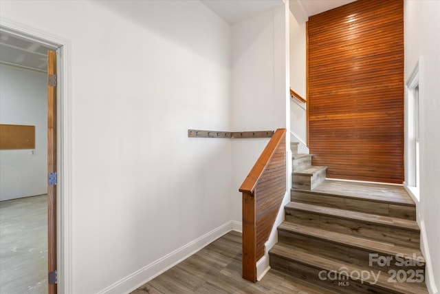 stairs featuring baseboards and wood finished floors