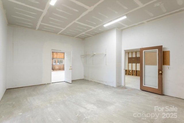 empty room with unfinished concrete flooring