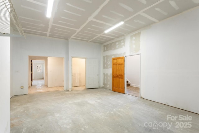 spare room with unfinished concrete floors