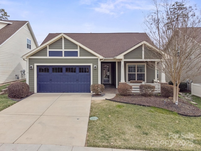 view of front of property featuring a garage, a front yard, driveway, and a shingled roof