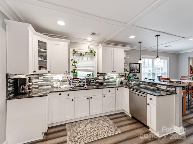 kitchen with crown molding, dishwasher, a peninsula, white cabinetry, and a sink