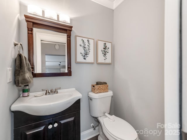 half bathroom featuring toilet and vanity