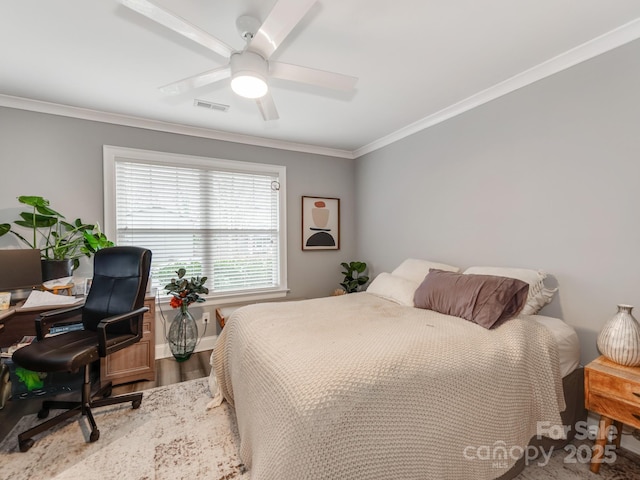 bedroom featuring visible vents, ornamental molding, a ceiling fan, wood finished floors, and baseboards