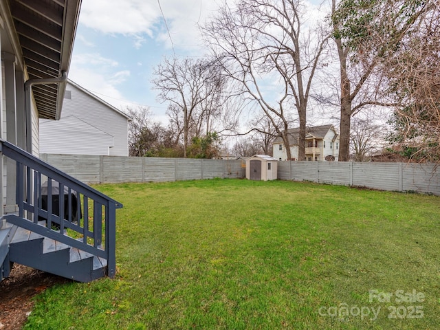 view of yard featuring an outdoor structure, a storage unit, and a fenced backyard