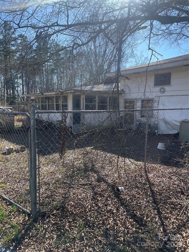 back of house featuring fence