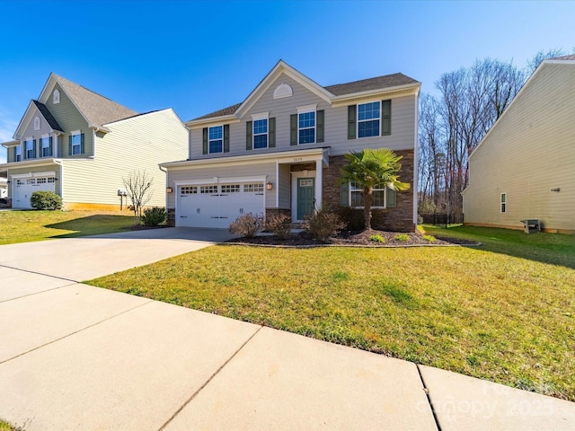 view of front of house featuring a garage, concrete driveway, and a front yard