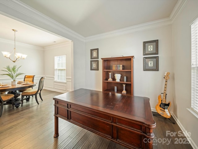 office space featuring crown molding, baseboards, wood finished floors, and an inviting chandelier