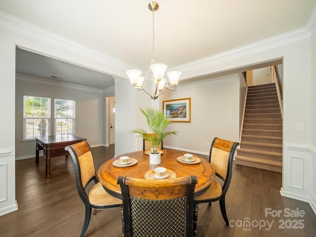 dining room featuring dark wood-style floors, stairway, an inviting chandelier, and crown molding